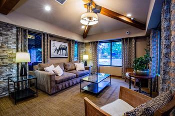 A living room with a stone wall and a moose picture.